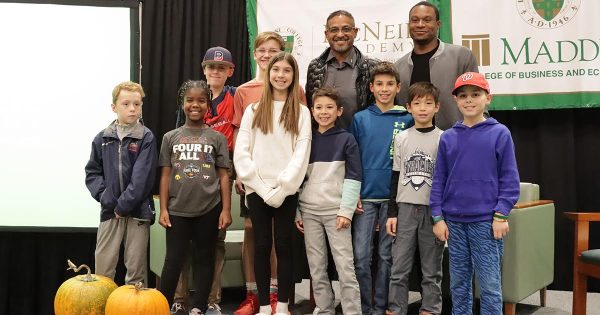 Roberto Clemente Jr. (left) and Le Moyne graduate Josiah Gray (right) with many of the children in the crowd for their talk at the Panasci Family Chapel